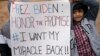 FILE - Demonstrators hold signs calling for the White House to reconsider admitting visa lottery winners who were denied access during the previous administration, in the Bronx borough of New York, March 24, 2021.