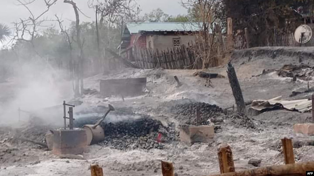 FILE - This handout photo from Pauk Township News taken and released June 16, 2021, shows the remains of houses allegedly set on fire by Myanmar junta forces, in Kin Ma village, Pauk township, in Myanmar's Magway region.