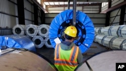 A worker uses a lift to move rolls of sheet metal at LMS International in Laredo, Texas, Nov. 21, 2016. Some U.S. border cities have thrived under NAFTA, such as Laredo and El Paso in Texas and Nogales in Arizona.