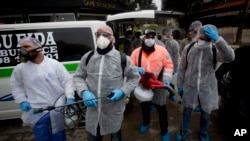 Palestinians workers in a protective suits get ready to disinfect mosques and churches as a preventive measure against the coronavirus in the West Bank city of Ramallah, March 7, 2020. 