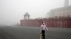 A man walks wearing a face mask amidst a thick layer of smog as air pollution shoots up in New Delhi, Nov. 18, 2024. Residents woke up to thick, toxic smog enveloping the city of some 33 million as the air quality became increasingly hazardous.