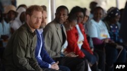 Prince Harry helps local schoolchildren to plant trees at the Chobe Tree Reserve in Chobe district, in the Northern Botswana on September 26, 2019