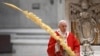 Pope Francis holds a palm branch as he celebrates Palm Sunday Mass behind closed doors in St. Peter's Basilica, at the Vatican, April 5, 2020, during the lockdown aimed at curbing the spread of the COVID-19 infection, caused by the novel coronavirus.