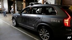 FILE - An Uber driverless car is displayed in a garage in San Francisco, Dec. 13, 2016. Uber announced Dec. 22, 2016, it is moving its self-driving cars to Arizona.