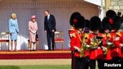 FILE - U.S. President Joe Biden, first lady Jill Biden and Britain's Queen Elizabeth stand in front of members of the Royal Guard, at Windsor Castle in Windsor, England, June 13, 2021.