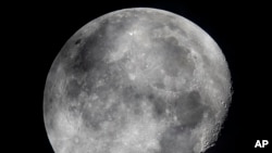 In this early Monday, Oct. 5, 2020, file photo, a waning moon is seen at the sky over Frankfurt, Germany. (AP Photo/Michael Probst, File)