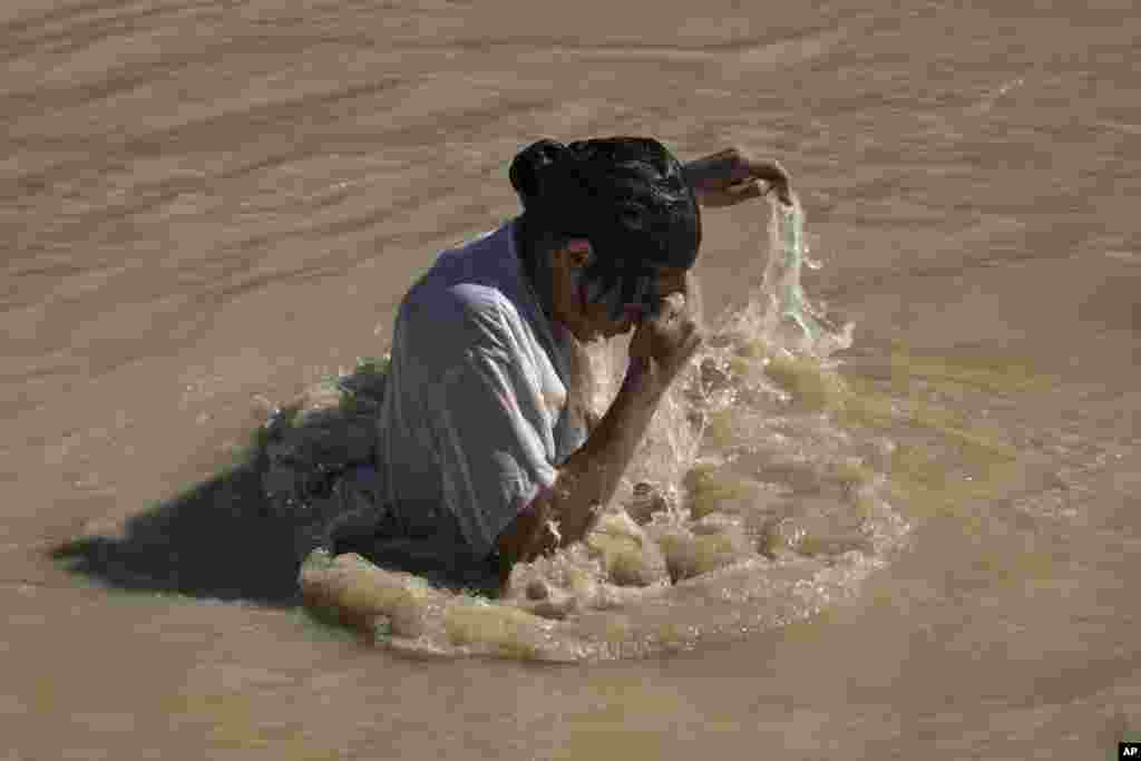 A Orthodox Christian pilgrim immerses himself in the Jordan River during a baptism ceremony as part of the Orthodox Feast of the Epiphany at Qasr el Yahud, near the West Bank town of Jericho.