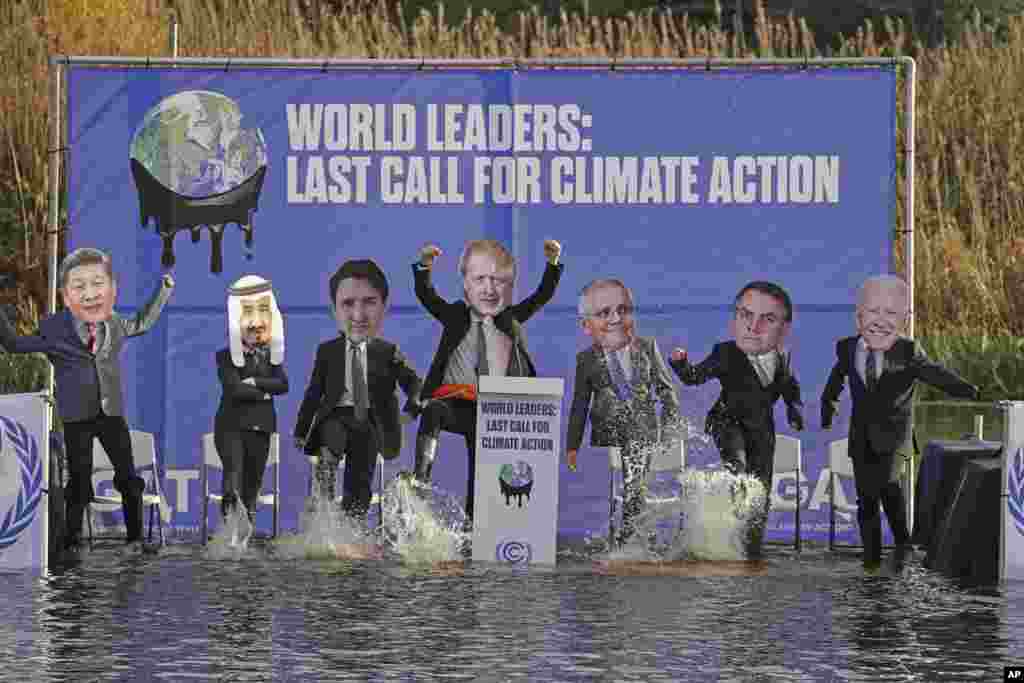 Climate change activists, dressed as world leaders, are seen during a demonstration in the Clyde Canal, during the COP26 summit in Glasgow, Scotland.