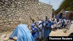 Believers pray for the release of kidnapped clergy members, in Port-au-Prince, April 12, 2021.