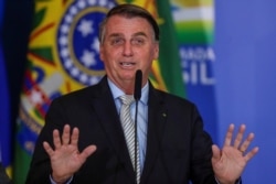 Brazil's President Jair Bolsonaro gestures at the Planalto Palace in Brasilia, Brazil, Feb. 24, 2021.