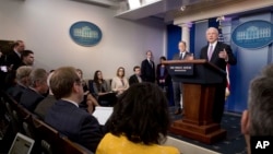 Attorney General Jeff Sessions, right, accompanied by White House press secretary Sean Spicer, second from right, talks to the media during the daily press briefing at the White House in Washington, Monday, March 27, 2017. 