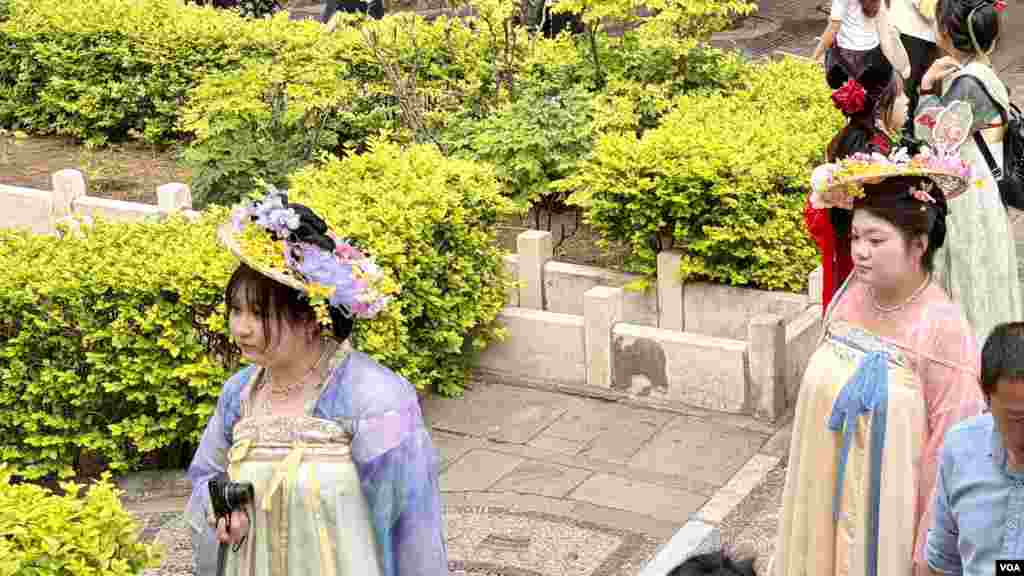 Chinese woman wearing traditional style “Hanfu" dresses inspired by ancient clothes worn by Han Chinese in the Forbidden City’s Imperial Garden.