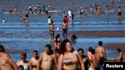 FILE - People try to cool off in the Rio de la Plata River during a heat wave, in Buenos Aires, Argentina, Jan. 9, 2022. 