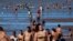FILE - People try to cool off in the Rio de la Plata River during a heat wave, in Buenos Aires, Argentina, Jan. 9, 2022. 