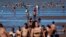 FILE - People try to cool off in the Rio de la Plata River during a heat wave, in Buenos Aires, Argentina, Jan. 9, 2022. 