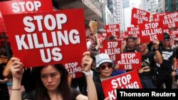 Protesters hold placards as they attend a demonstration demanding Hong Kong's leaders to step down and withdraw the extradition bill, in Hong Kong, June 16, 2019. 