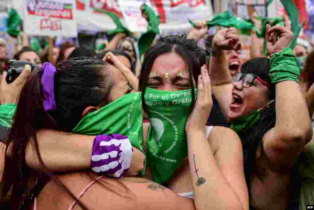 Demonstrators celebrate with green headscarves — the symbol of abortion rights activists —outside the Argentine Congress in Buenos Aires after legislators passed a bill to legalize abortion.