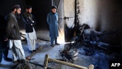 Pakistani tribesmen gather at the site following an attack by Taliban militants in Mohmand district on Feb. 18, 2016. 