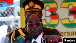 Zimbabwe President Robert Mugabe addresses crowds gathered for the country's 33rd independence celebrations at the National Sports stadium in Harare, April 18, 2013.