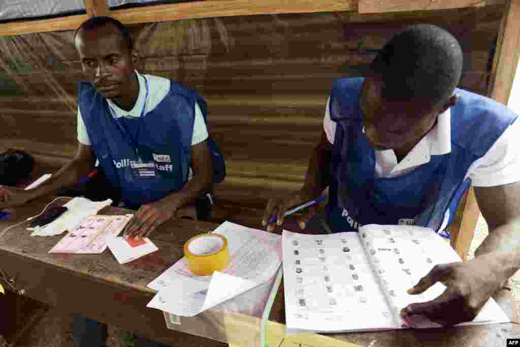 Des membres de la Commission électorale nationale alors que les Libériens se rendent aux urnes pour le second tour des élections présidentielles, à Monrovia, le 26 décembre 2017.