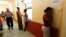 FILE - An Eritrean would-be immigrant talks on the phone at the Lyster barracks detention center for immigrants in Hal Far, outside Valletta, Malta.