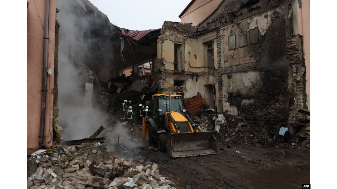 A digger arrives to help rescuers remove rubble from a school destroyed during an overnight missile attack on the town of Slоviansk, Donetsk region, Ukraine, on Feb. 18, 2024.