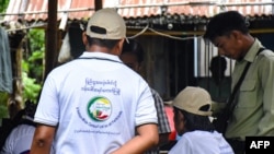 Census enumerators collect information during a national census in Naypyidaw on October 1, 2024. Census takers guarded by police and soldiers took to the streets of Myanmar on October 2 for a national survey that anti-junta groups have urged people to boycott.