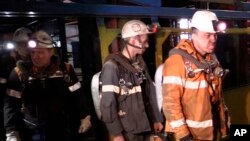 Photo provided by Russian Emergency Situations Ministry press service on Feb. 28, 2016 shows rescuers leaving an elevator in Vorkuta. Officials say a total of 36 people are believed to have died at a coal mine where a methane gas leak triggered three explosions and the collapse of the mine. 