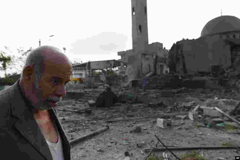 Palestinian Khaled Sharmi, 67, walks past the Al Aqsa Martyrs mosque, destroyed by an overnight Israeli strike, in Gaza City, July 22, 2014.