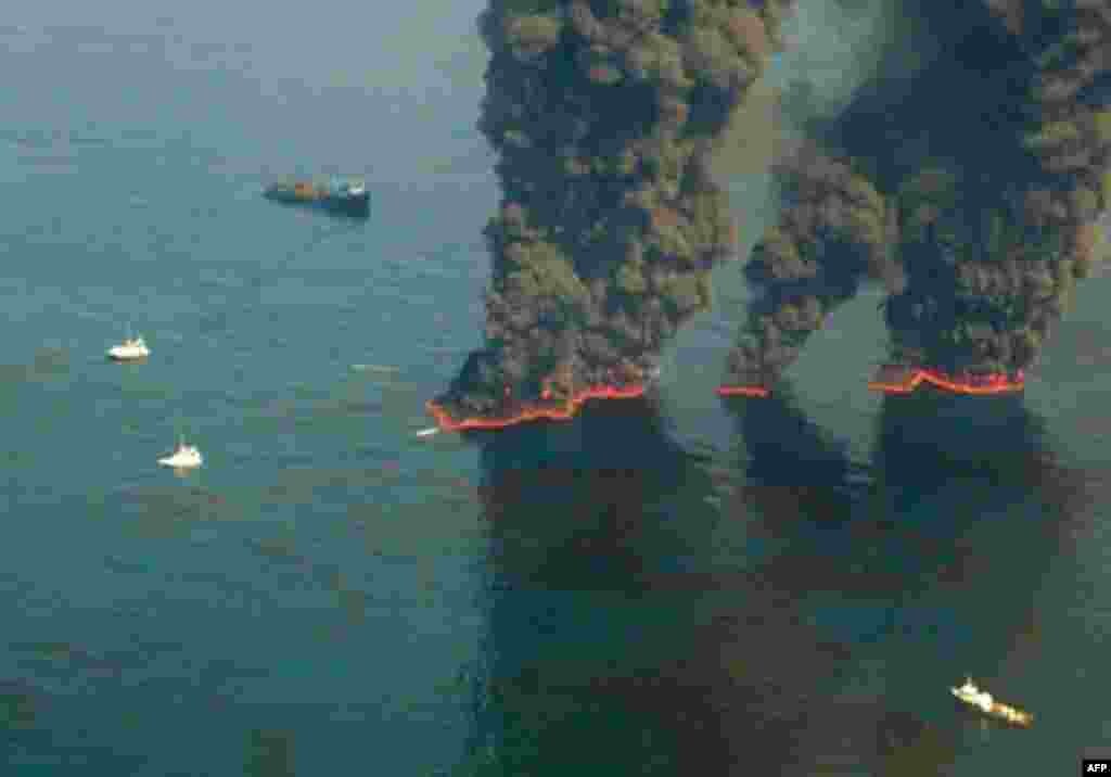 This US Coast Guard handout image shows crews conducting overflights of controlled burns taking place in the Gulf of Mexico, 19 May 2010. (AFP Image)