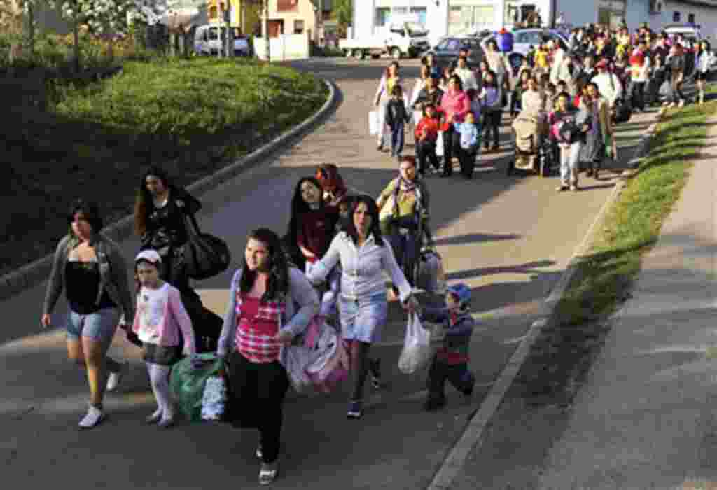 Gypsies march with their possessions through the village of Gyongyospata, eastern Hungary, April 22, 2011