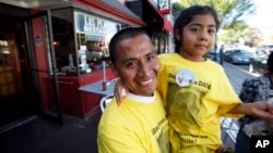 Raul Cruz, from suburban Los Angeles, holds his daughter Sophie Cruz, 5, after an interview with AP in Washington, Sept. 23, 2015. 