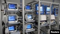 FILE - Ventilators of Hamilton Medical AG are seen at a plant in Domat/Ems, Switzerland, March 18, 2020. 