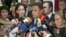 Brazilian Senator Aecio Neves (C) speaks to the media next to Lilian Tintori (R), wife of opposition leader Leopoldo Lopez, Patricia Ceballos (back L), mayor of San Cristobal and wife of jailed former mayor Daniel Ceballos, and opposition leader Maria Corina Machado (2nd L), at the Simon Bolivar airport in Caracas, June 18, 2015.
