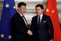 Chinese President Xi Jinping, left, and Italian Prime Minister Giuseppe Conte shake their hands following the signing of a memorandum in support of Beijing's "Belt and Road" initiative, at Rome's Villa Madama, March 23, 2019.