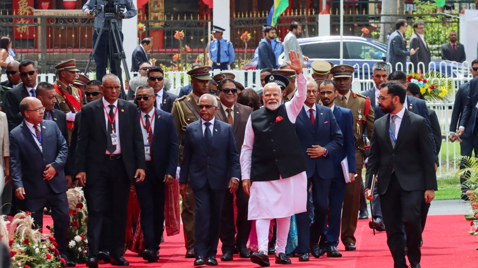 India's Prime Minister Narendra Modi waves as he arrives for Mauritius' 57th National Day celebrations at the Champ De Mars, Port Louis, Mauritius, March 12, 2025. 