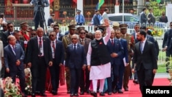 India's Prime Minister Narendra Modi waves as he arrives for Mauritius' 57th National Day celebrations at the Champ De Mars, Port Louis, Mauritius, March 12, 2025. 