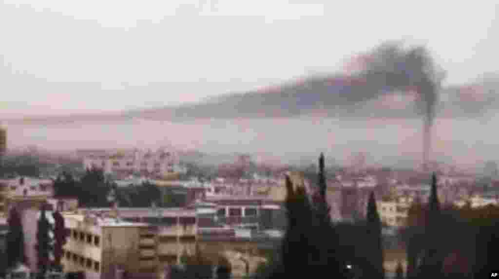 This image from amateur video purports to show smoke rising in Homs, Syria, February 16, 2012. (AP / Shaam)
