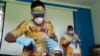 FILE - Workers prepare face shields from recycled plastics at the Zaidi Recyclers workshop as a measure to stop the spread of coronavirus disease (COVID-19) in Dar es Salaam, Tanzania, May 21, 2020.