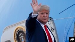 FILE - U.S. President Donald Trump waves when boarding Air Force One as he leaves from the airport in Helsinki, Finland, July 16, 2018.