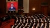 Chinese Premier Li Keqiang is shown on a large screen as he delivers a work report at the opening session of the annual National People's Congress at the Great Hall of the People in Beijing, March 5, 2018.