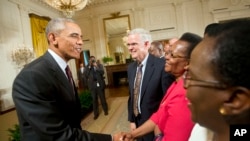 President Barack Obama shakes hands with guests after speaking during a reception in the East Room of the White House in Washington, July 22, 2015. The reception was to celebrate the recent signing into law of the African Growth and Opportunity Act (AGOA)