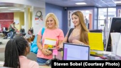 Students ask for assistance at one of the support service offices on the Valencia College campus in Orlando, Florida.