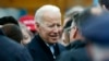 FILE - Former vice president Joe Biden talks with officials after speaking at a rally in support of striking Stop & Shop workers in Boston.