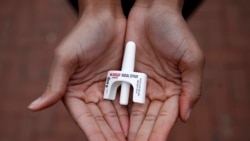 FILE - In this Jan. 23, 2018, file photo, Leah Hill, a behavioral health fellow with the Baltimore City Health Department, displays a sample of Narcan nasal spray in Baltimore, Maryland. The drug is a critical tool to easing America's opioid crisis. (AP Photo/Patrick Semansky)