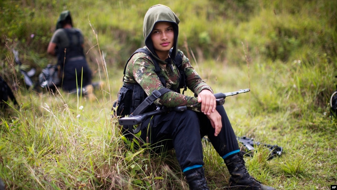 Juliana, a 20-year-old rebel fighter for the 36th Front of the Revolutionary Armed Forces of Colombia, or FARC, rests from a trek in the northwest Andes of Colombia, Jan. 6, 2016.