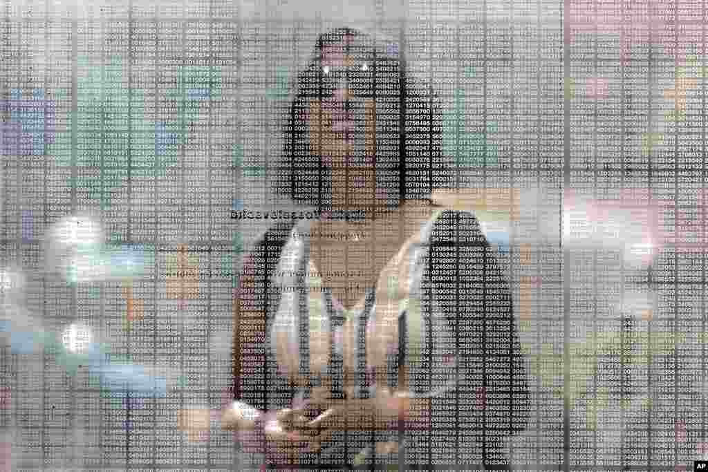 A woman stands behind the rows of numbers etched onto the Holocaust Memorial in Boston, August 12, 2021. The numbers represent the six million Jews murdered in the Holocaust.