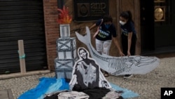 Activists hold a cutout depicting a whale skeleton on World Ocean Day, in Rio de Janeiro, Brazil June 8, 2021.