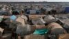 Residents walk past tents at the Bab Al-Salam refugee camp in Azaz, near the Syrian-Turkish border, Nov. 19, 2014.