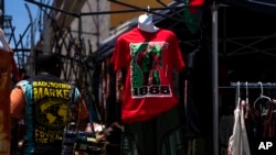 FILE: A Juneteenth T-shirt is for sale in Los Angeles, Friday, June 17, 2022. Retailers and marketers from Walmart to Amazon have been quick to commemorate Juneteenth with an avalanche of merchandise from ice cream to T-shirts to party favors.